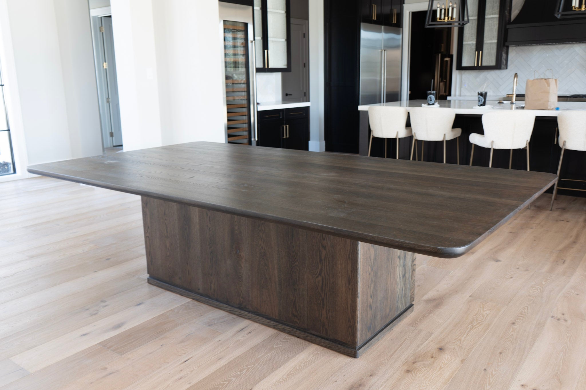 Large wooden dining table in a modern kitchen setting