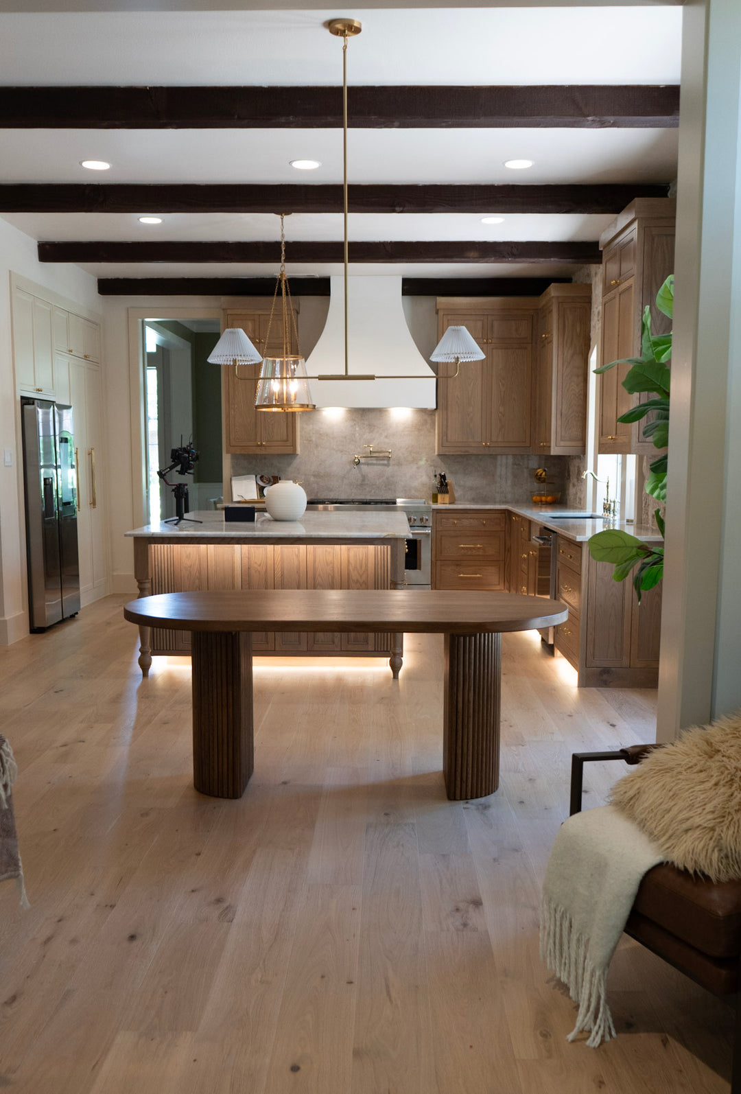 Modern kitchen with wooden dining table and light wood flooring