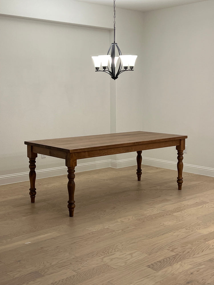 Special walnut-stained maple rectangular dining table with four pedestal legs, showcasing rich color and elegant craftsmanship.