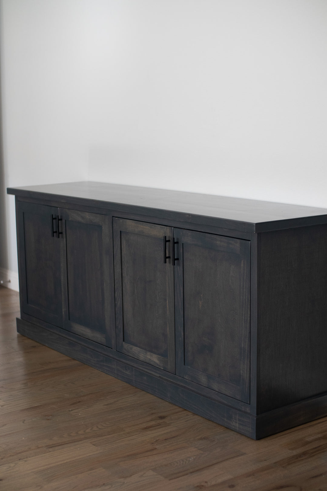 This spacious gray credenza features a modern and minimalist design. It's perfect for enhancing your living room or office space while helping you keep your belongings organized.