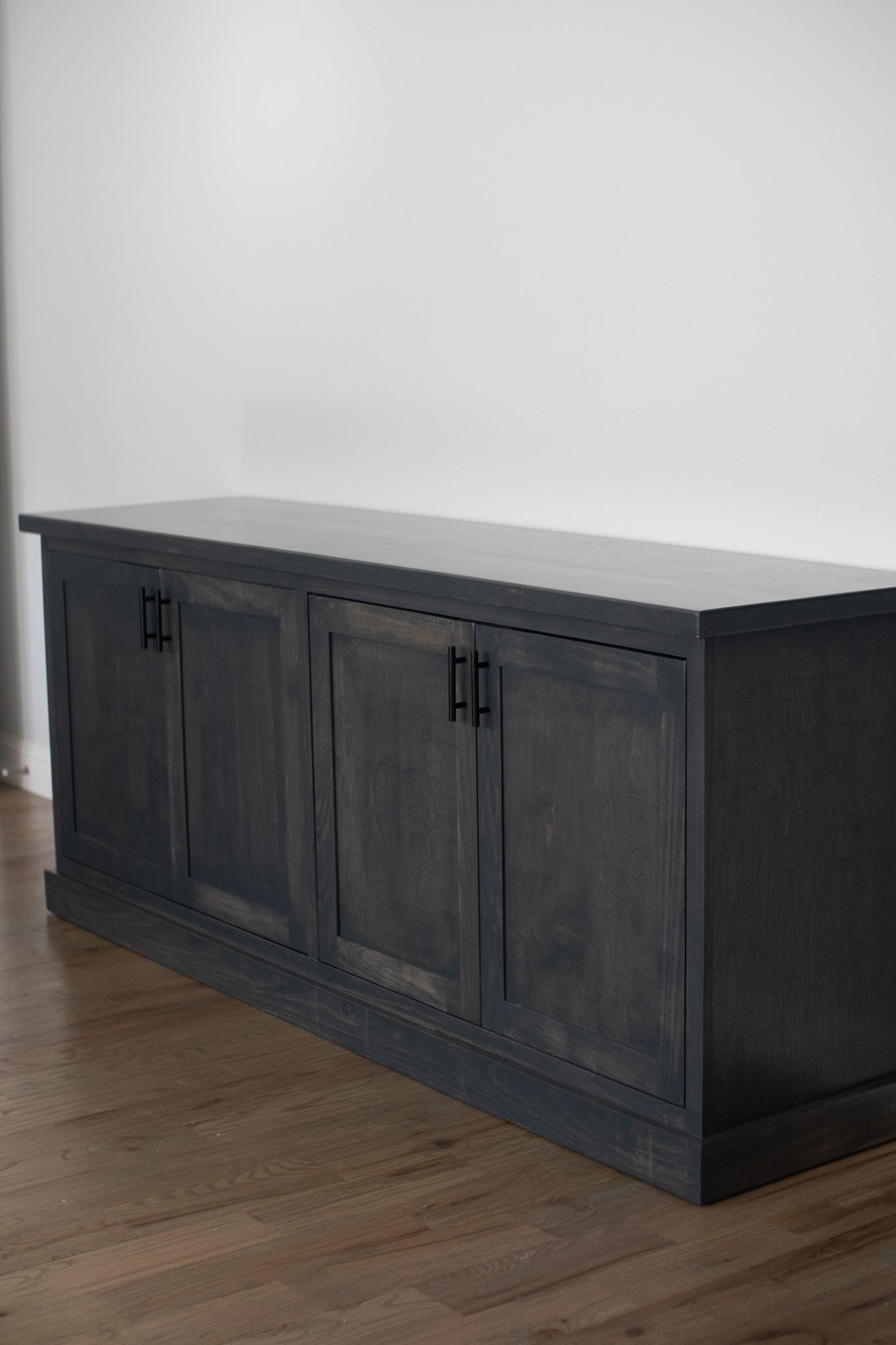 This spacious gray credenza features a modern and minimalist design. It's perfect for enhancing your living room or office space while helping you keep your belongings organized.
