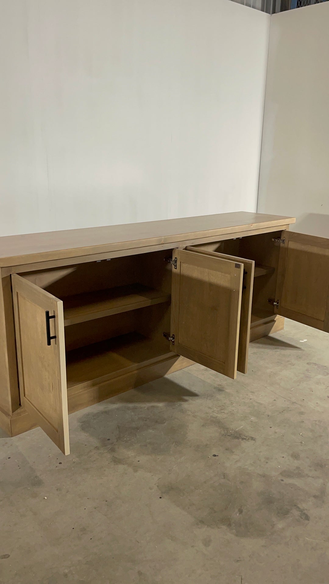credenza with all the doors open to showcase the interior of the credenza