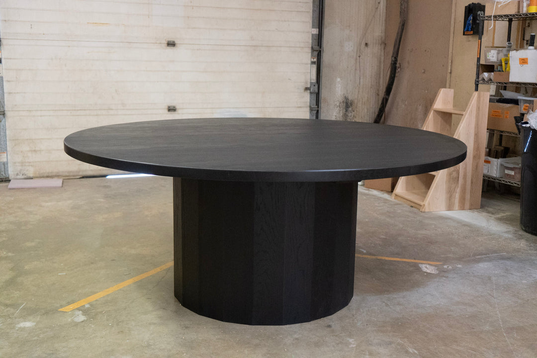 Black round table in a warehouse setting