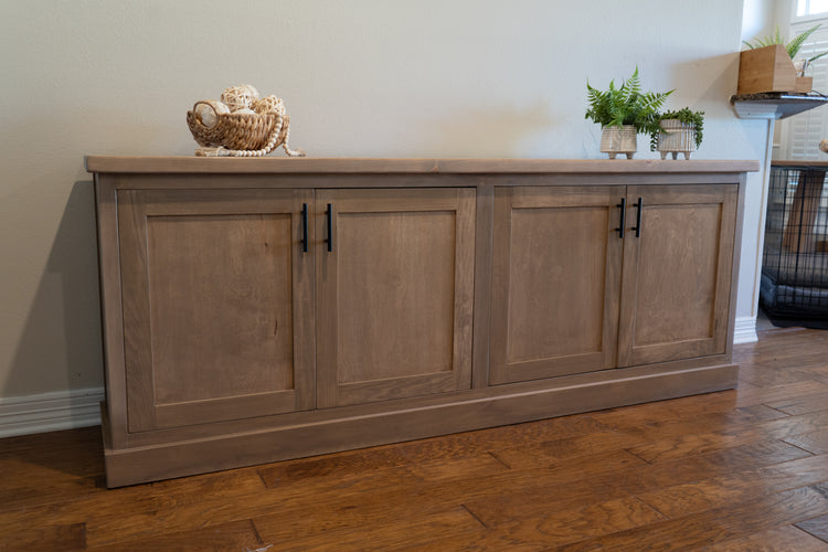 brown credenza sitting in a large entryway with a few cute decorations