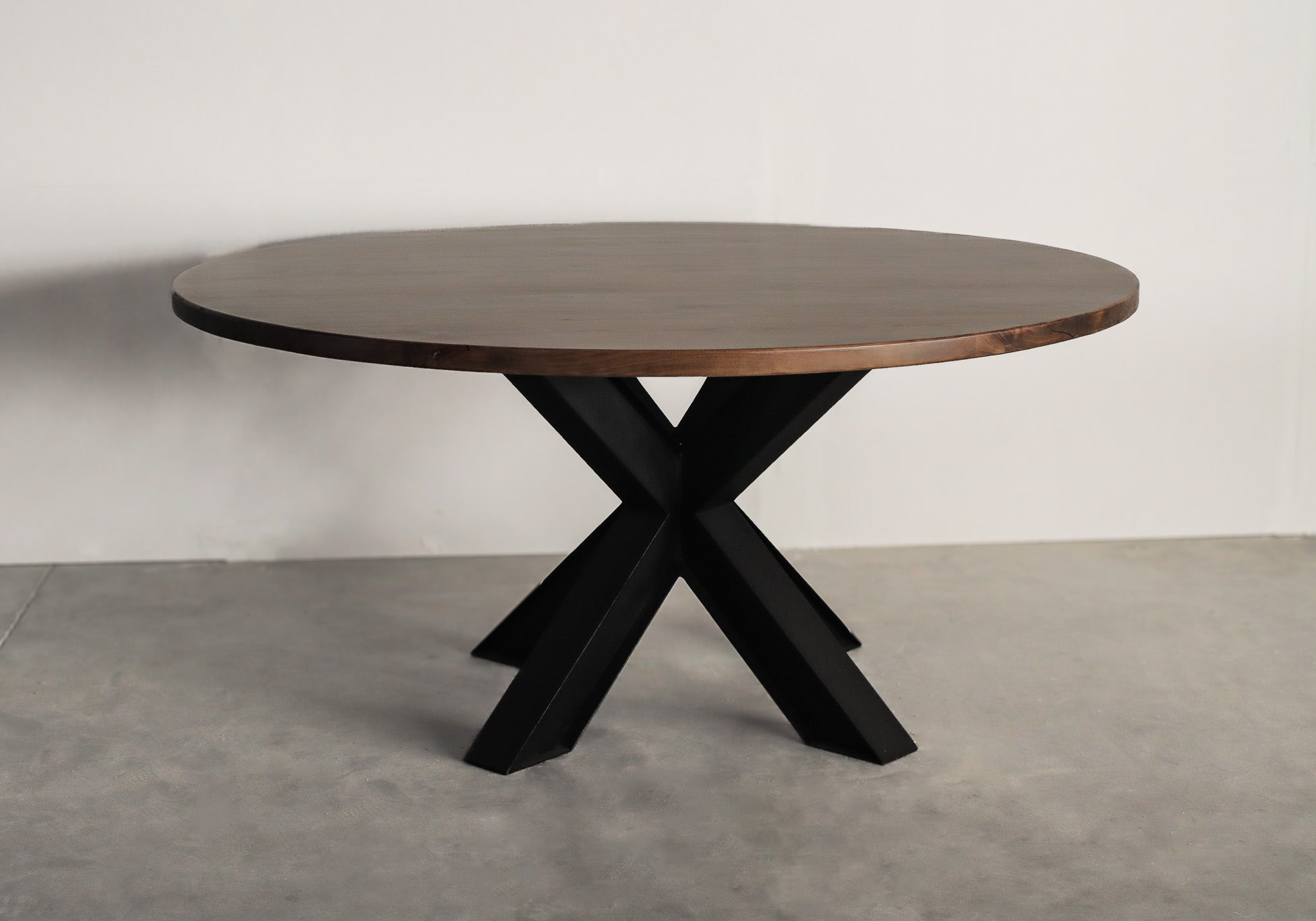 Round hardwood top sitting on a black metal spider base, showcasing a stylish blend of natural wood and industrial design.
