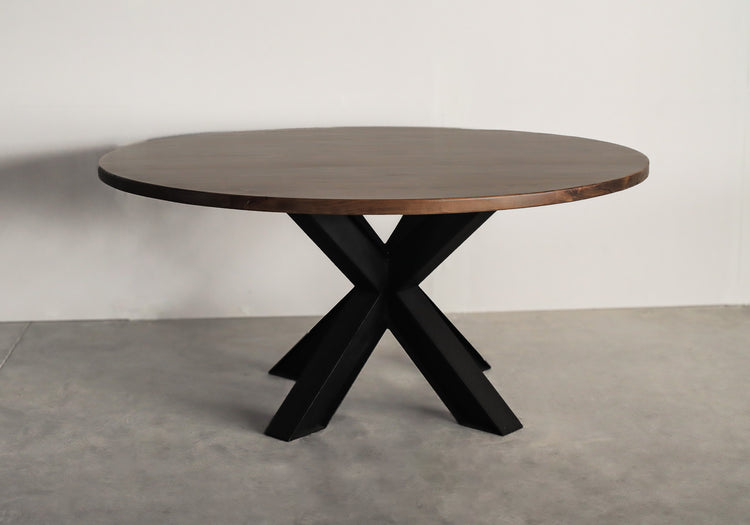 Round hardwood top sitting on a black metal spider base, showcasing a stylish blend of natural wood and industrial design.