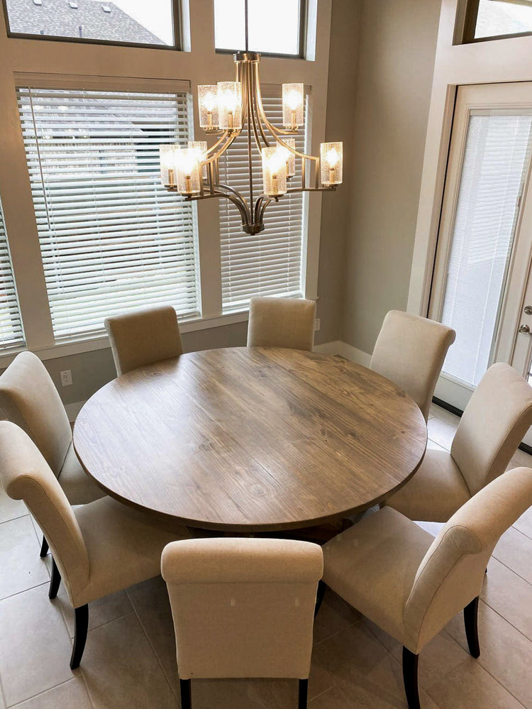 A spacious 72-inch dining table is encircled by eight upholstered chairs.