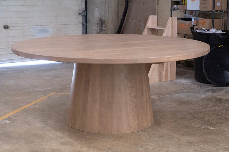 maple cylinder round table in a warehouse setting