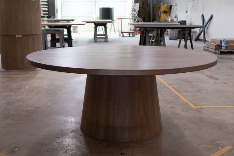 Large wooden cone round table in a warehouse setting