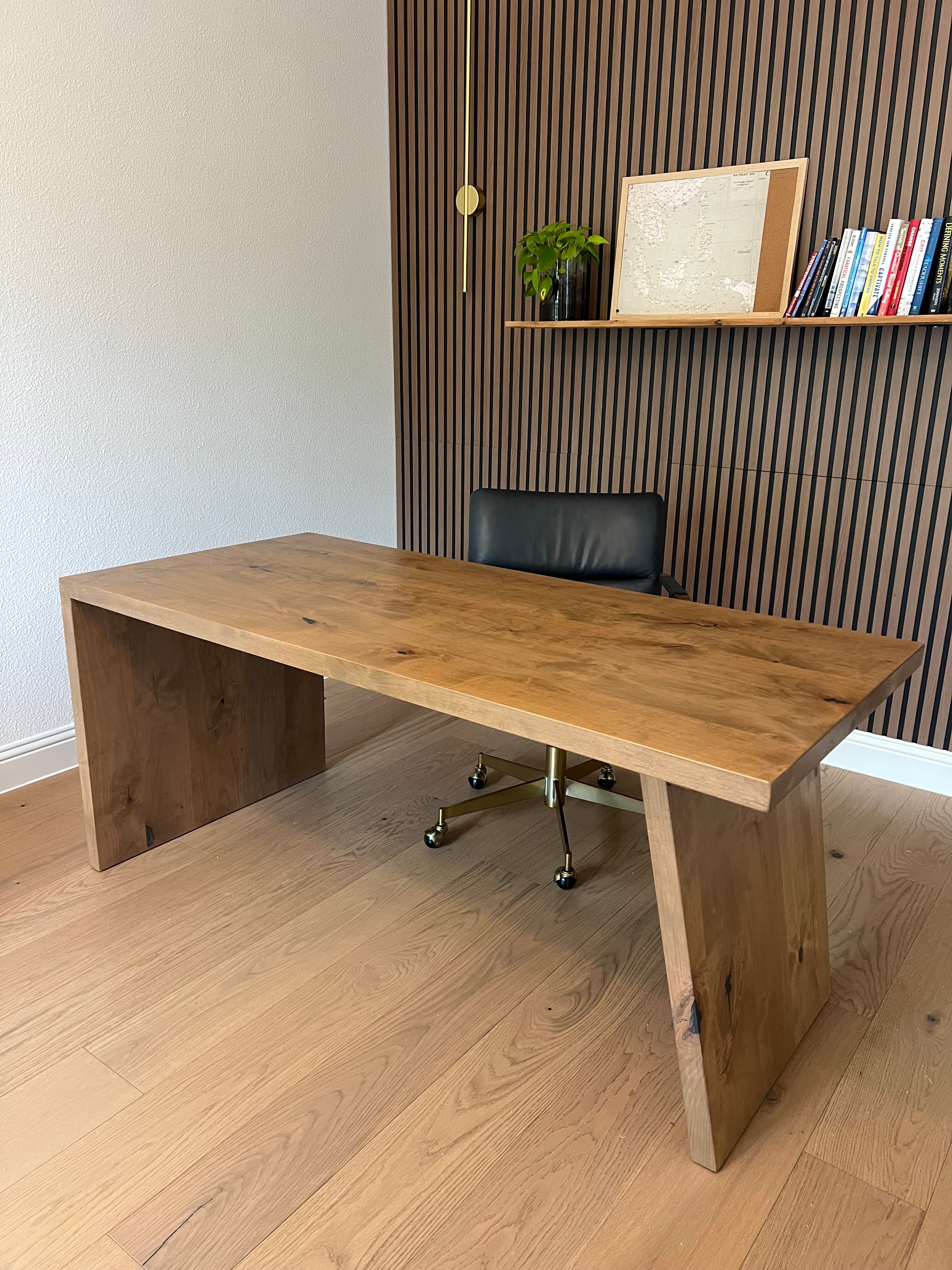 Wooden desk with a chair in an office setting