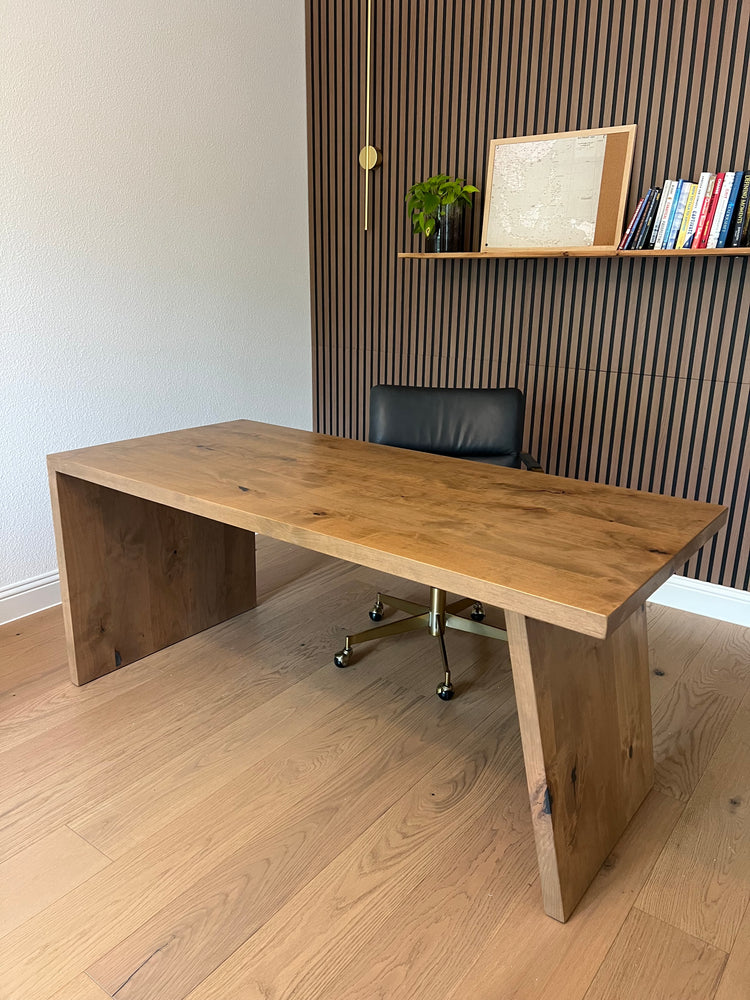 Wooden desk with a chair in an office setting