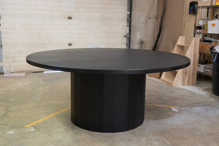 Black round table in a warehouse setting