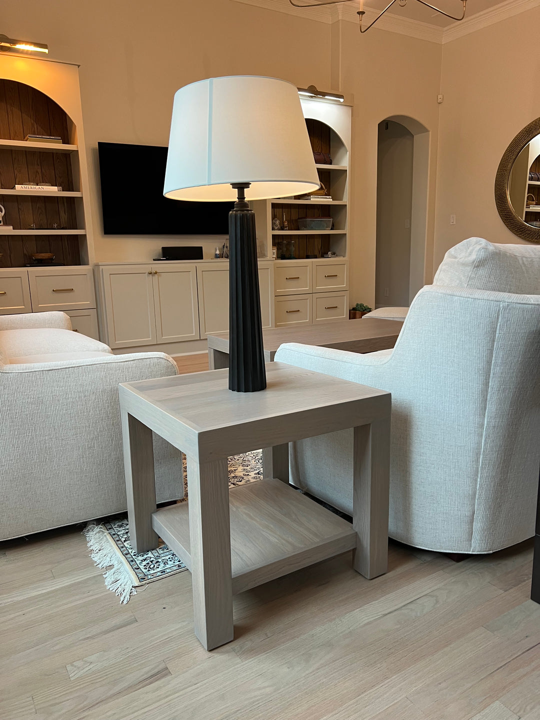 Living room with gray chairs, light gray sidetable, and lamp.